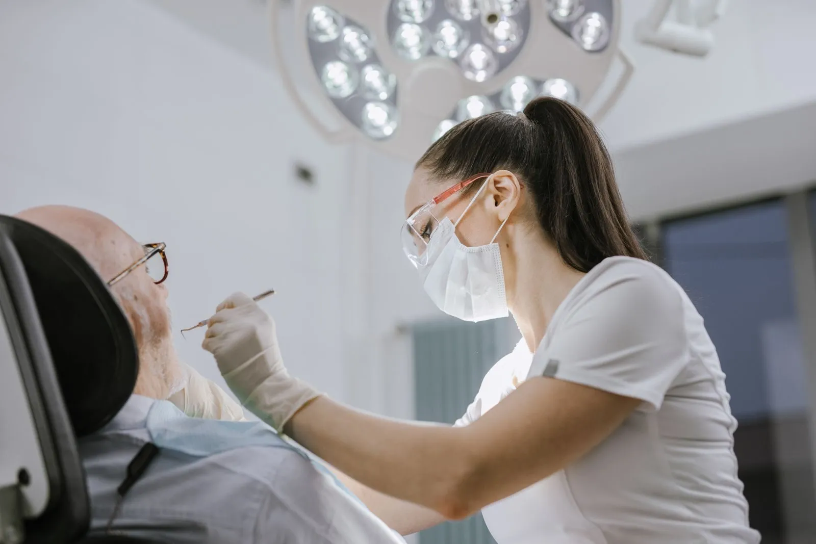 A dentist working with a patient in a modern dental chair