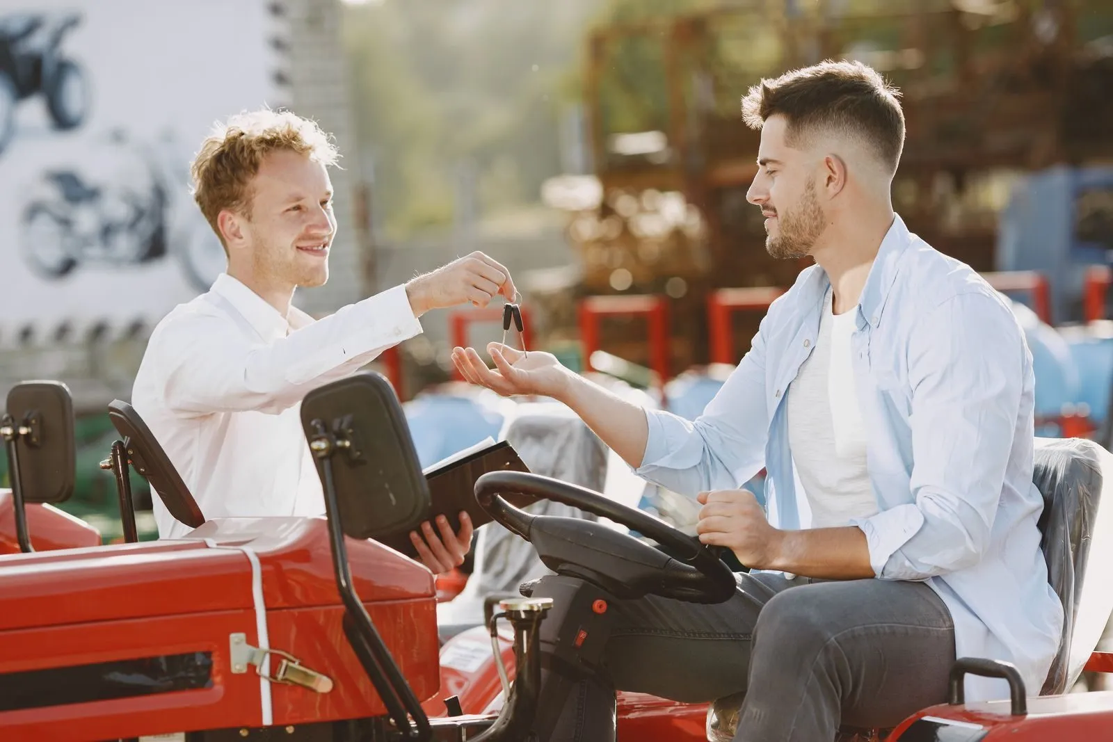 A buyer receiving the keys to his equipment at a dealership