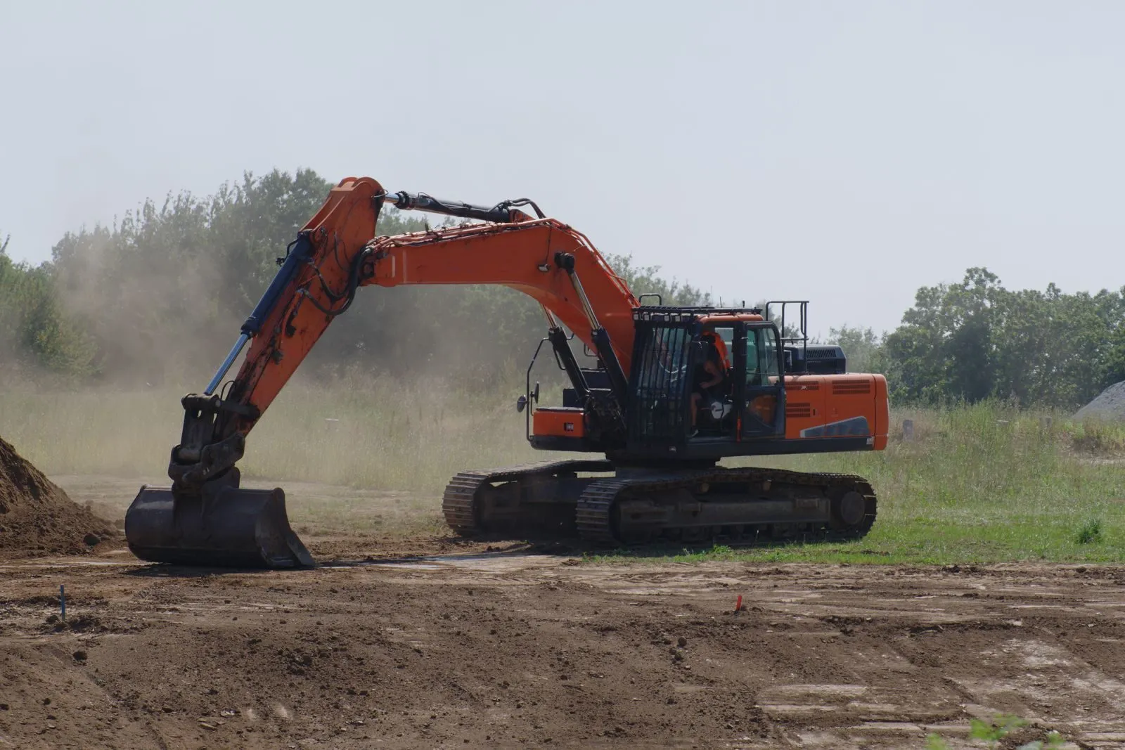 An excavator digging on an open job site