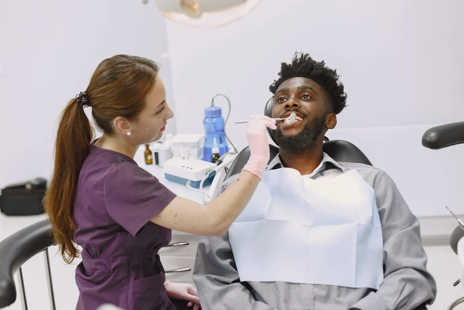 A dentist working with a smiling patient