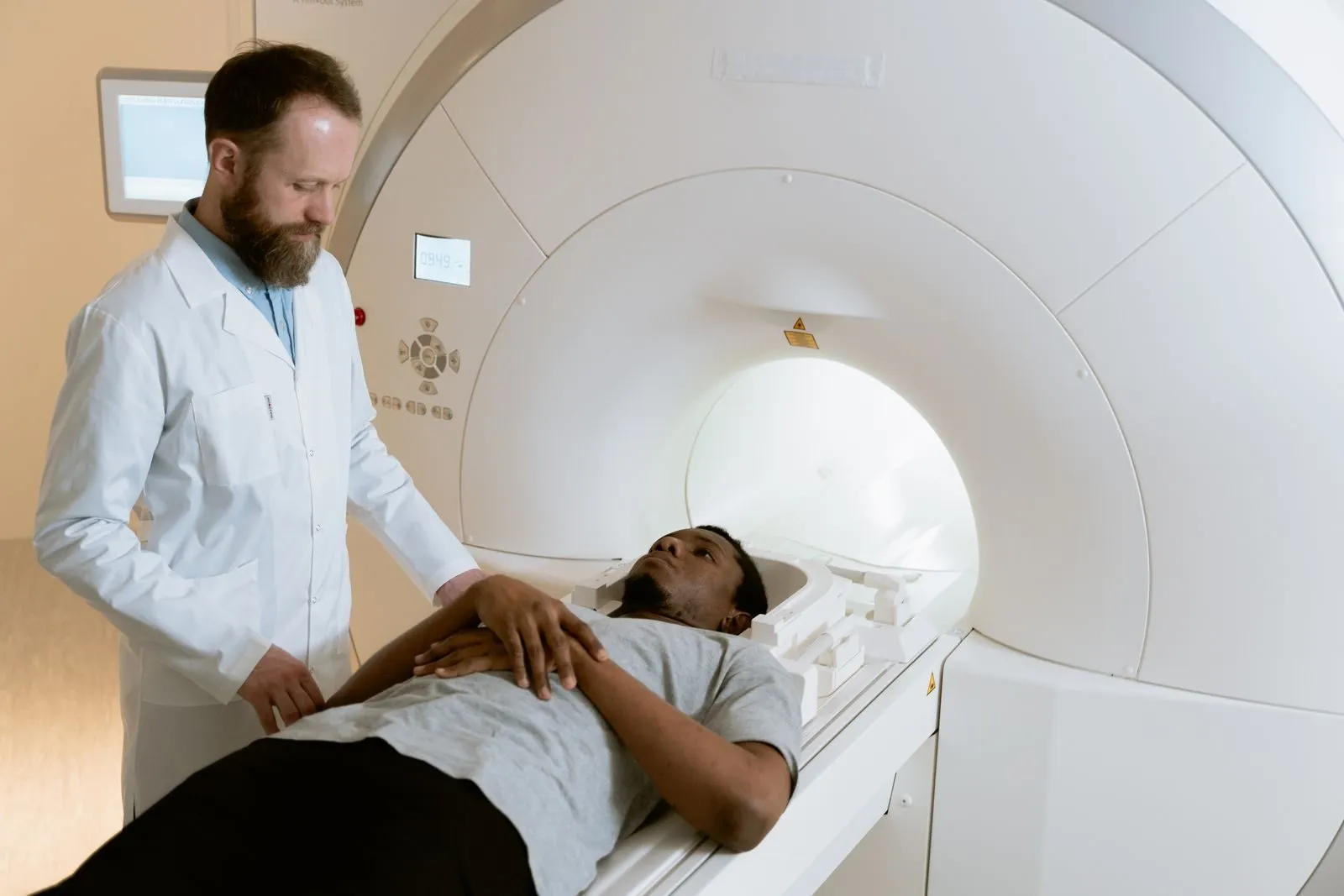 A technician preparing a patient for an MRI scan