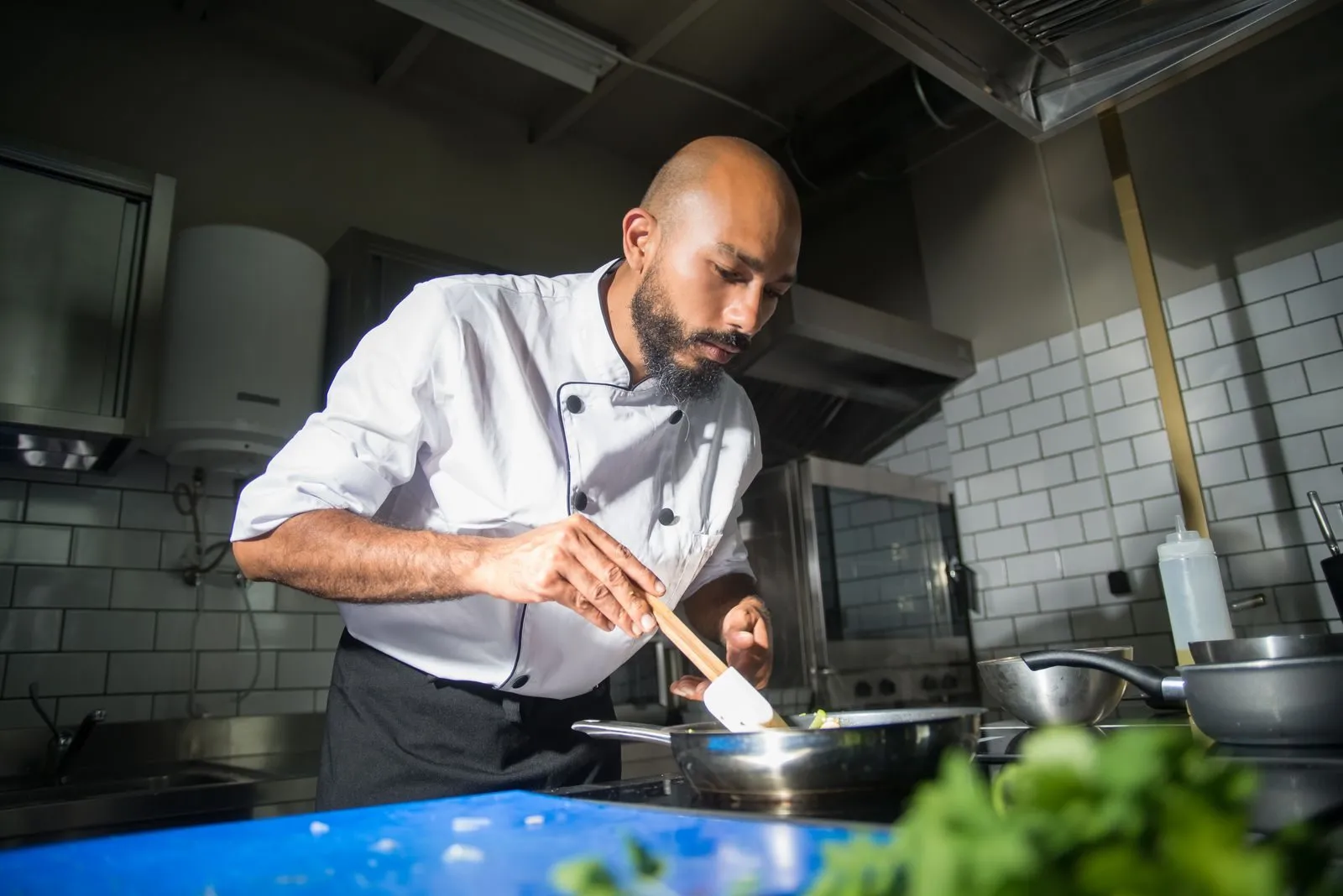 A chef cooking on the line in a commercial kitchen